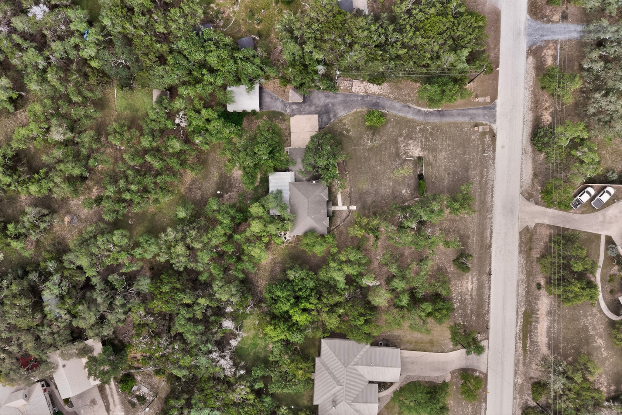 1003 Pier Branch Road Dripping Springs, TX 78620 - Photo 8 of 40 An aerial perspective showcases a property nestled amongst natural tree cover with convenient road access.