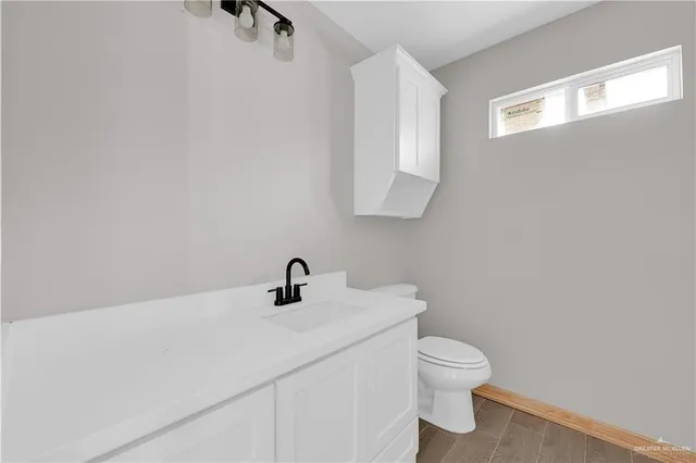 a bathroom with a toilet sink and mirror