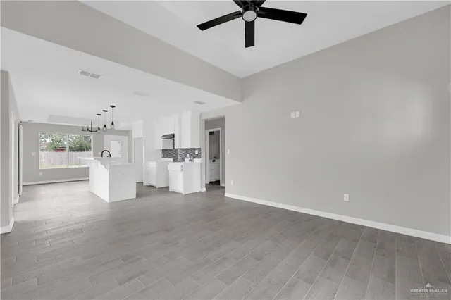 a view of a kitchen with a sink refrigerator and window