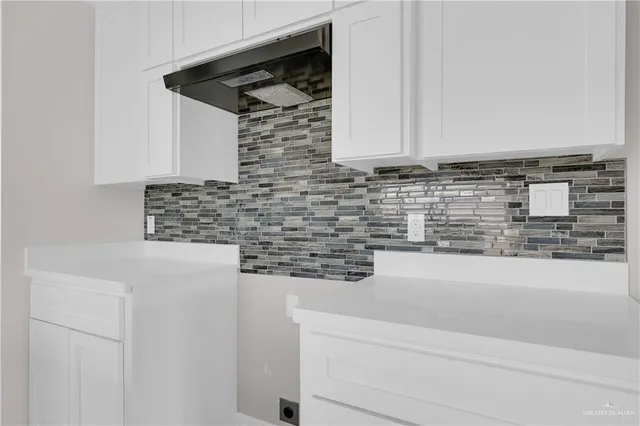 a bathroom with a granite countertop white sink and a granite counter top