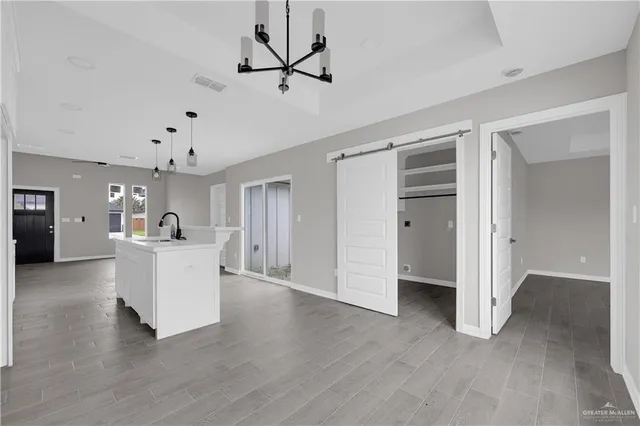 a view of a living room and kitchen with a flat screen tv