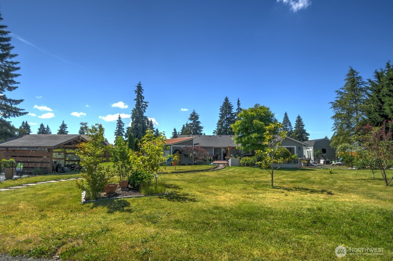 5922 184th Lane Southwest Rochester, WA 98579 - Photo 22 of 34 a swimming pool with outdoor seating and yard