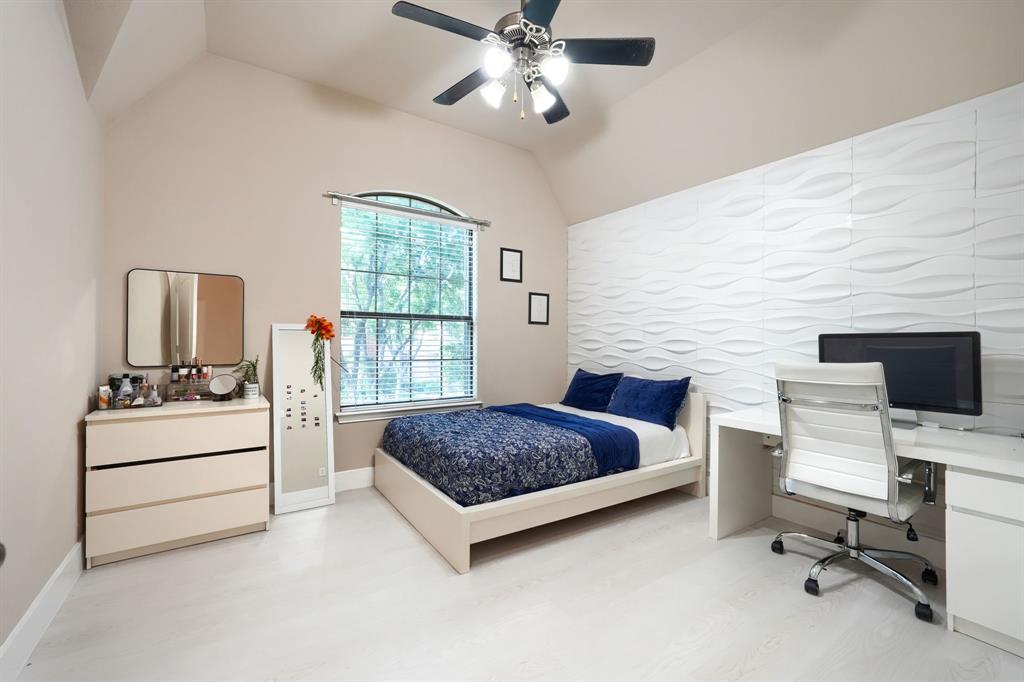 2246 Longview Road Irving, TX 75063 - Photo 35 of 40 Room featuring an arched window with blinds, a vaulted ceiling, and a ceiling fan with integrated lighting
