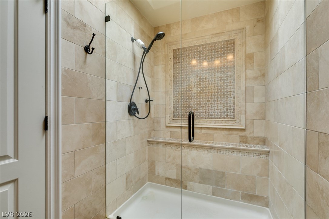 9325 West Desert Inn Road, Unit 244 Las Vegas, NV 89117 - Photo 34 of 55 A pristine shower enclosure features textured tiling and a clear glass door.