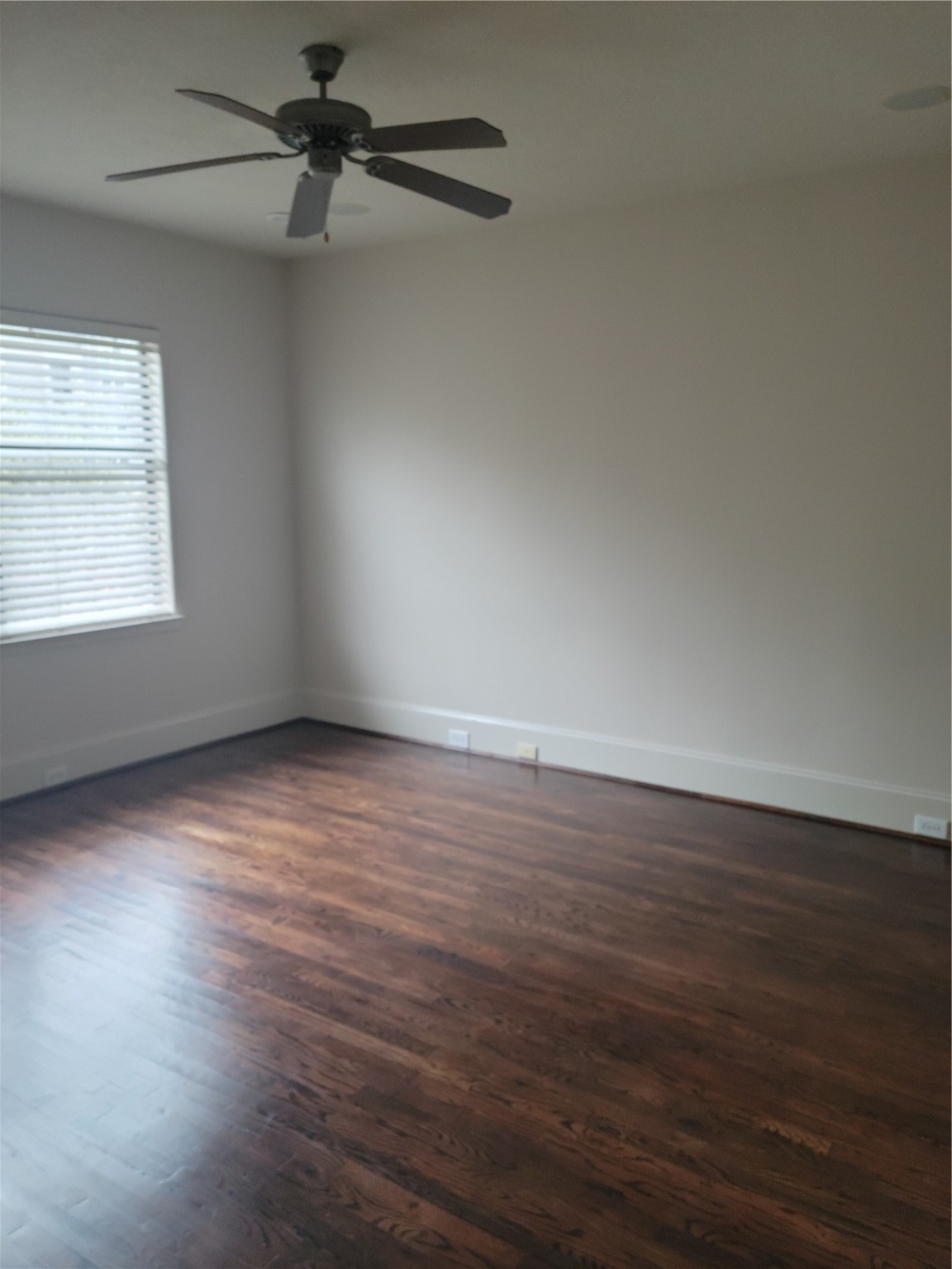 703 St Charles Street Houston, TX 77003 - Photo 12 of 24 an empty room with wooden floor fan and windows