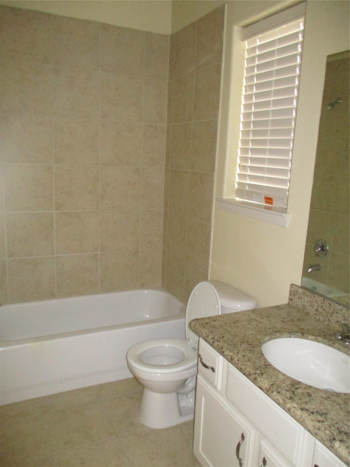 703 St Charles Street Houston, TX 77003 - Photo 17 of 24 a bathroom with a granite countertop sink a toilet and a bathtub