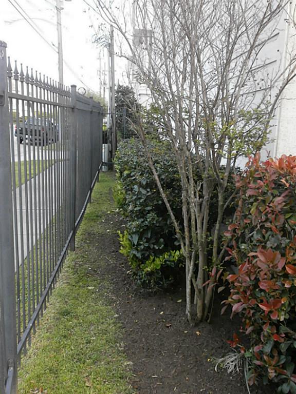 703 St Charles Street Houston, TX 77003 - Photo 3 of 24 a view of a pathway of a yard with wooden fence