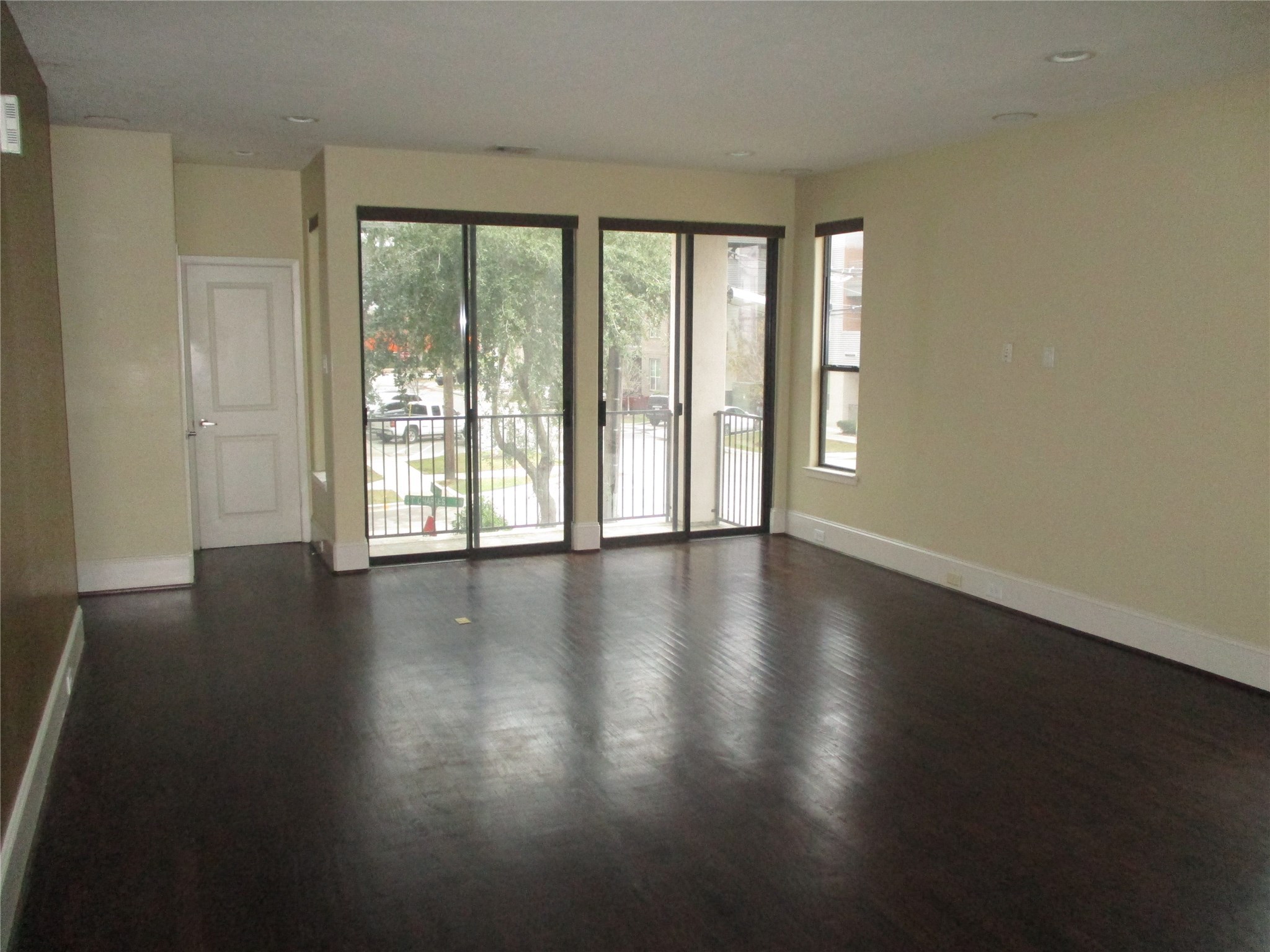 703 St Charles Street Houston, TX 77003 - Photo 7 of 24 a view of an empty room with wooden floor and a window