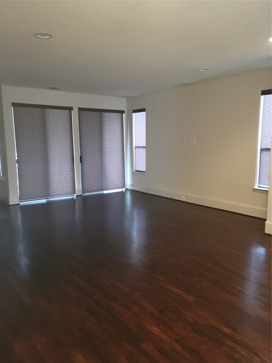 703 St Charles Street Houston, TX 77003 - Photo 8 of 24 a view of an empty room with wooden floor and a window