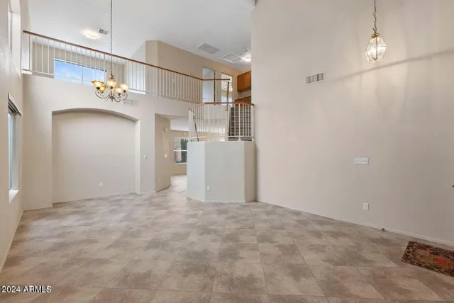a view of a kitchen with a refrigerator and a stove top oven