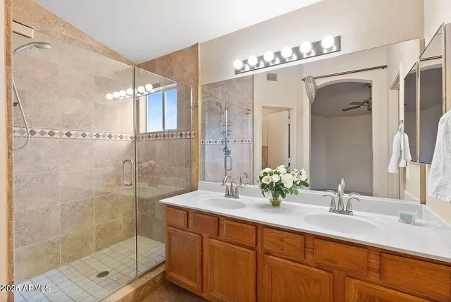 a bathroom with a sink mirror shower and toilet