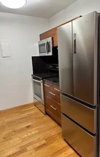 a room with a refrigerator and a television