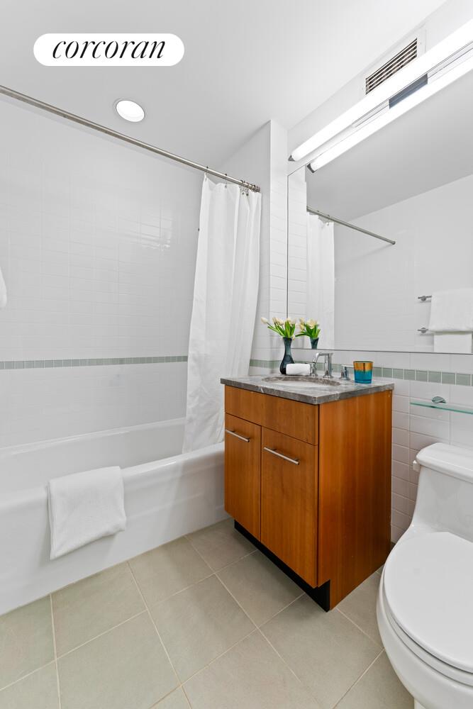 11 East 29th Street, Unit 24C Manhattan, NY 10016 - Photo 10 of 17 a bathroom with a granite countertop sink and a mirror
