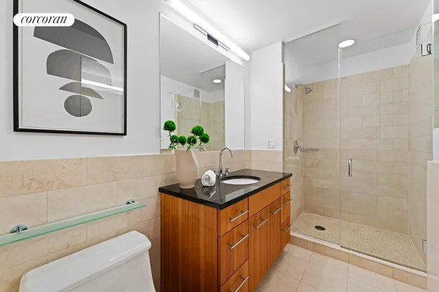 a bedroom with bed and cabinets