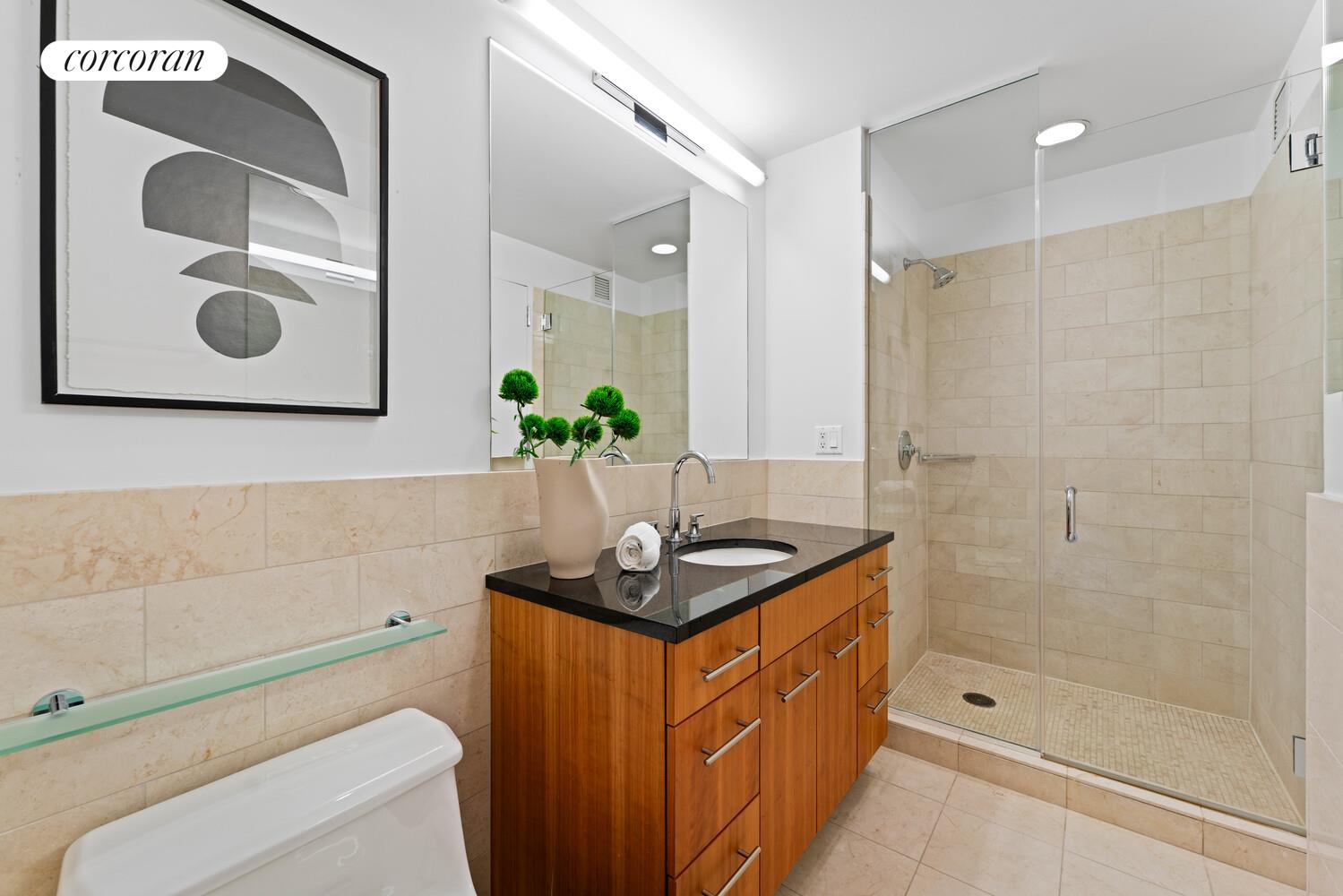 11 East 29th Street, Unit 24C Manhattan, NY 10016 - Photo 8 of 17 a bathroom with a granite countertop sink a toilet and shower
