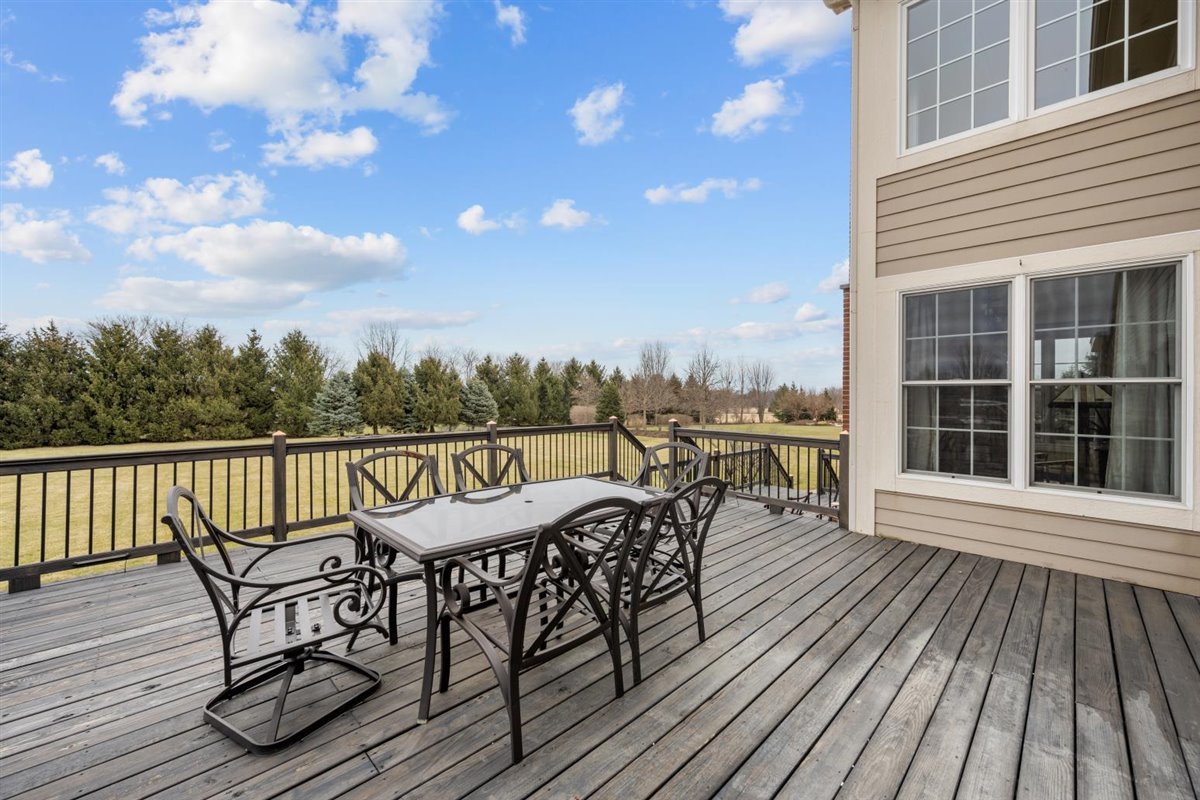 1-n203 East Blackberry Crossing Circle Elburn, IL 60119 - Photo 28 of 30 a view of a roof deck with table and chairs with wooden floor and fence