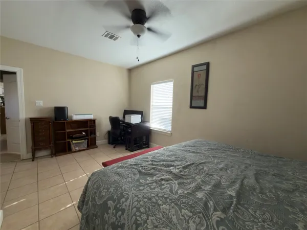 a bed room with a bed and a television