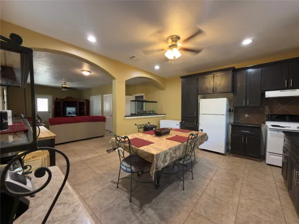 a living room with furniture and kitchen view