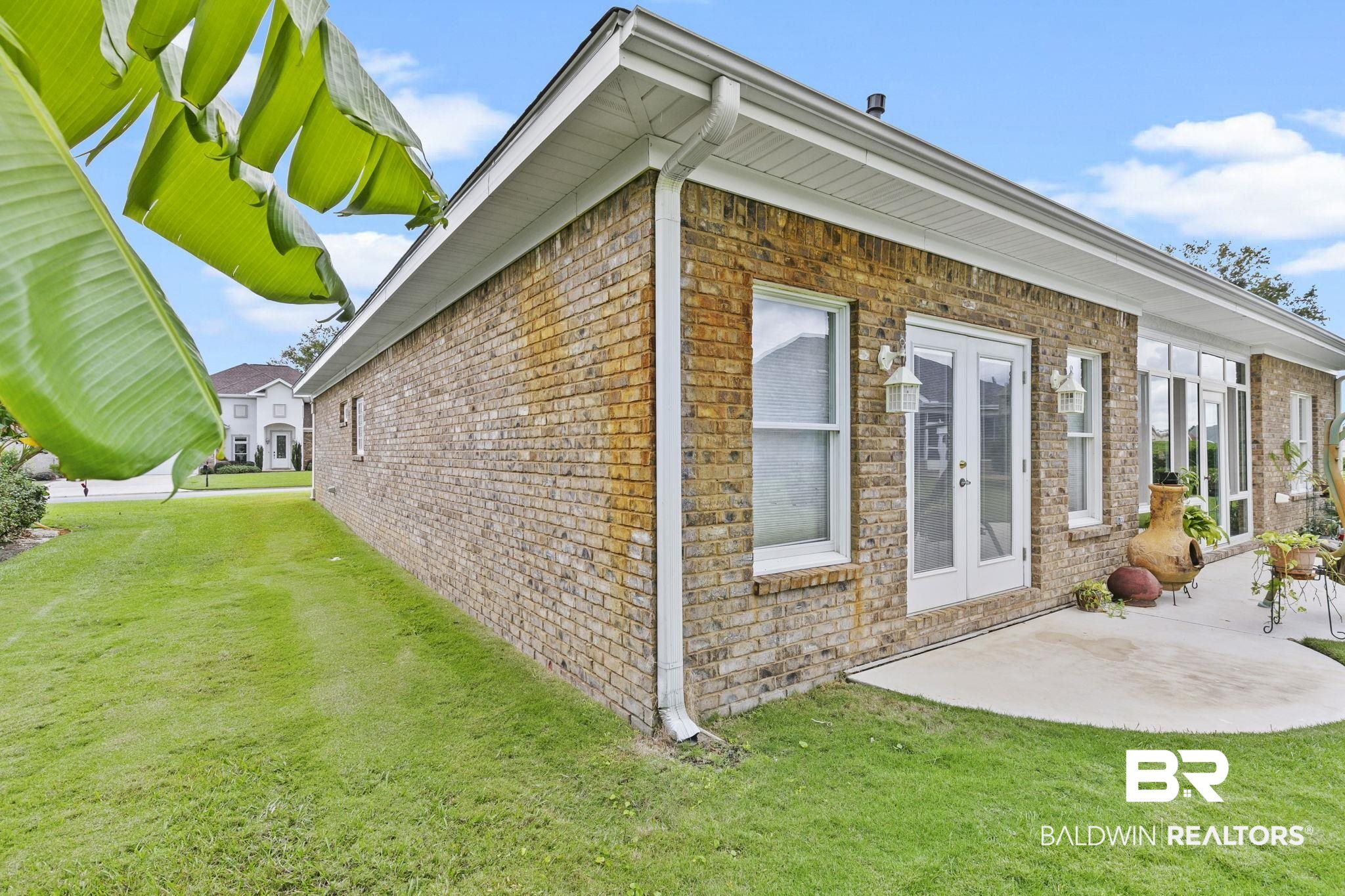 22512 Inverness Way Foley, AL 36535 - Photo 38 of 43 View of property exterior with french doors, a lawn, and a patio area