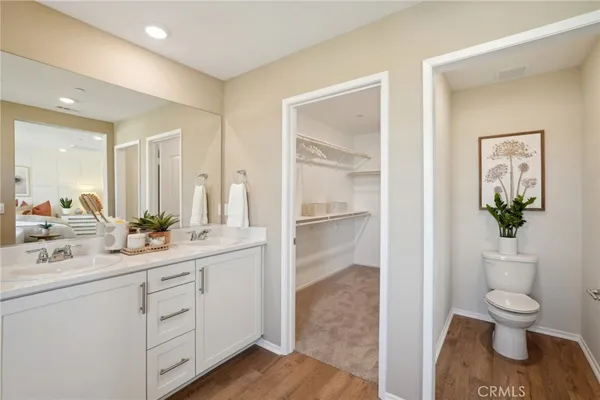a en suite bathroom with a double vanity sink a mirror and a shower