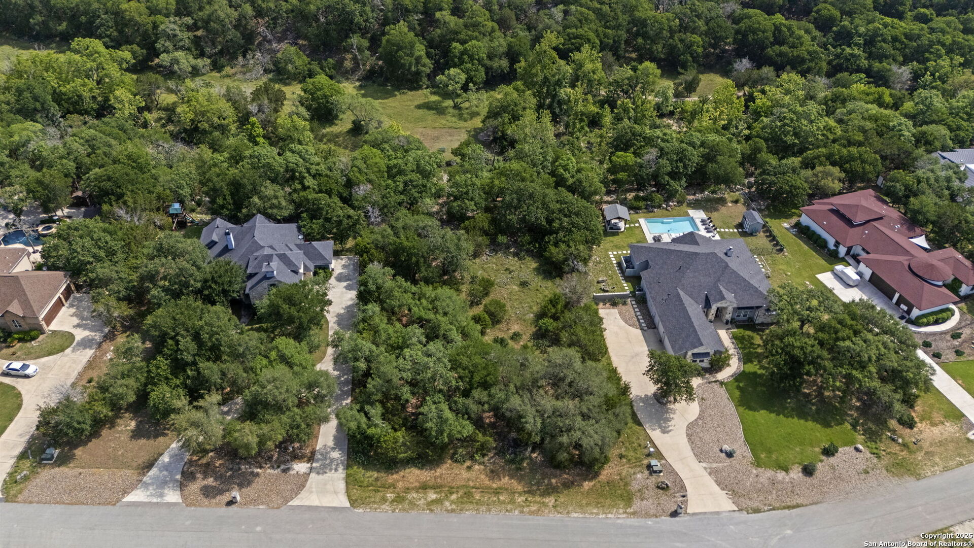 1030 Jurassic Lane Spring Branch, TX 78070 - Photo 4 of 7 an aerial view of a house with a yard