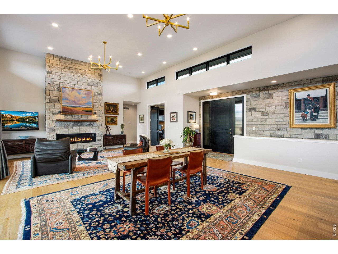 4186 Prestwich Court Timnath, CO 80547 - Photo 24 of 48 a living room with furniture a flat screen tv and kitchen view