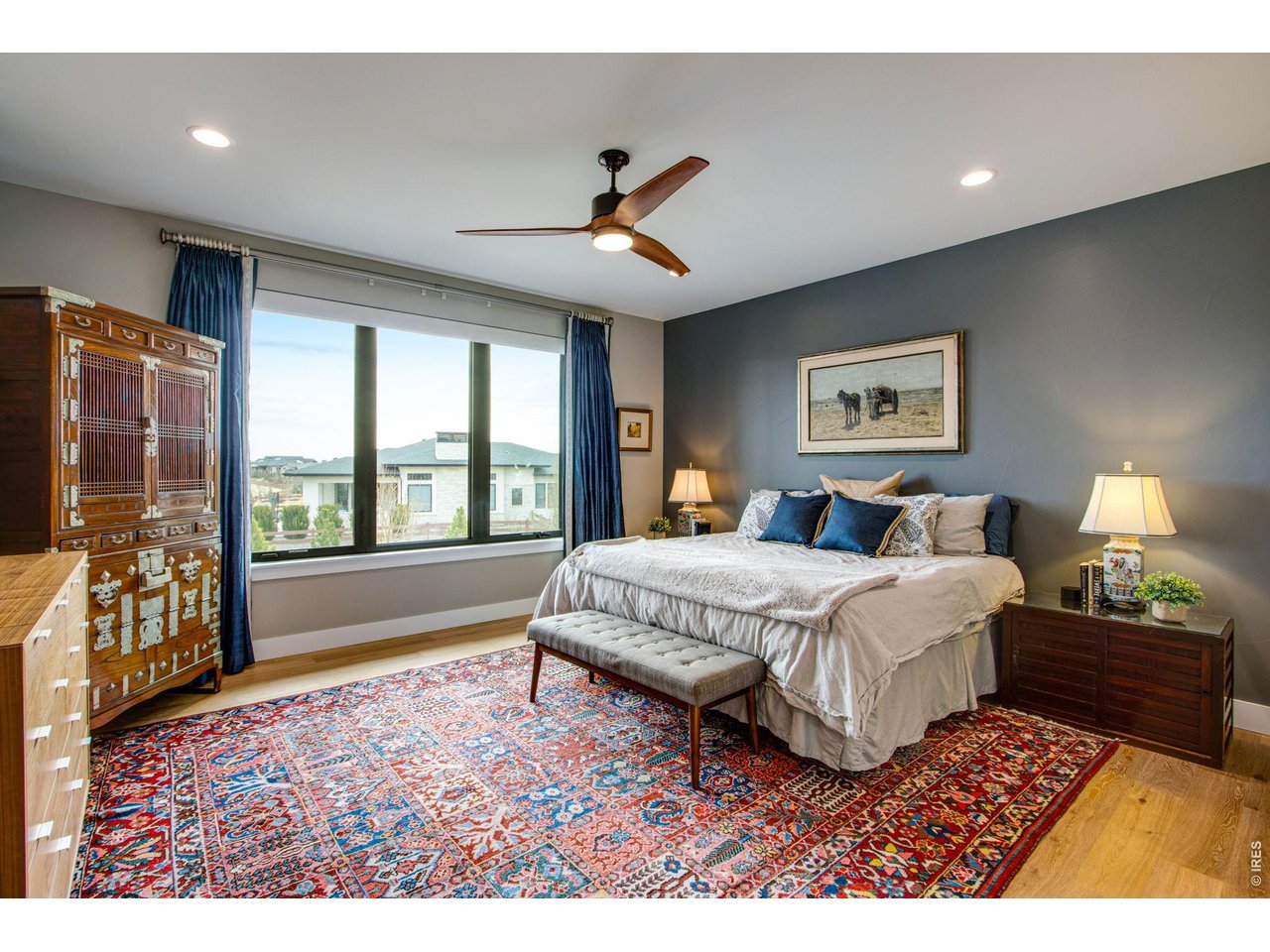 4186 Prestwich Court Timnath, CO 80547 - Photo 36 of 48 a spacious bedroom with a large bed and a chandelier