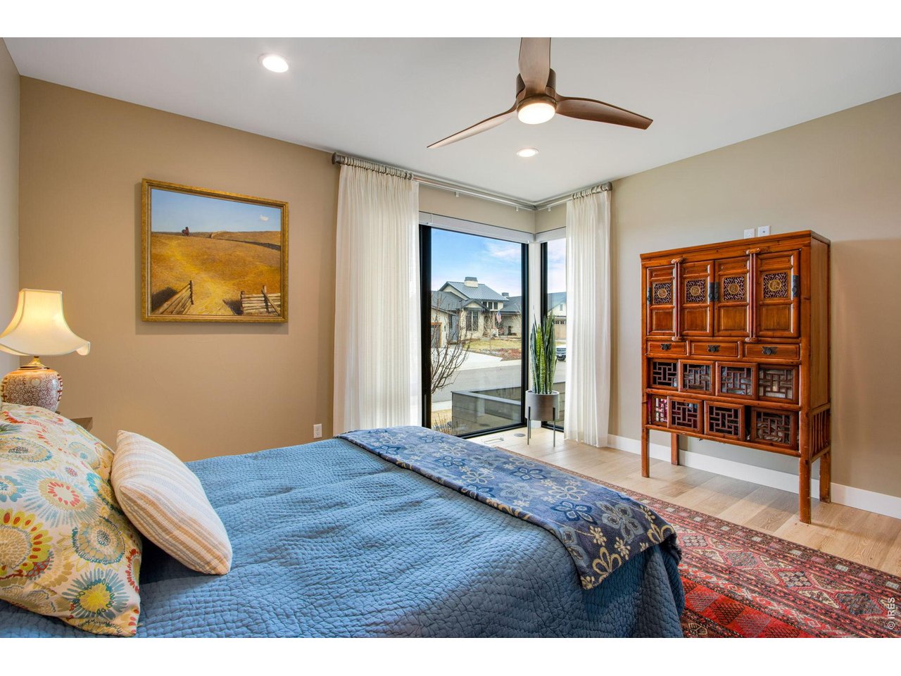 4186 Prestwich Court Timnath, CO 80547 - Photo 39 of 48 a bedroom with a bed and a chandelier