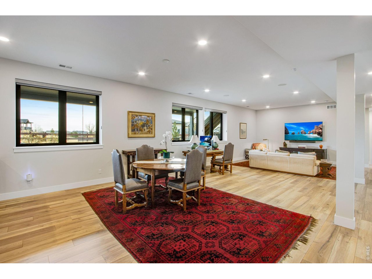 4186 Prestwich Court Timnath, CO 80547 - Photo 43 of 48 a living room with furniture a dining table and wooden floor