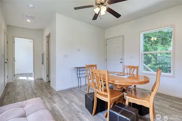 a view of a dining room with furniture window and wooden floor