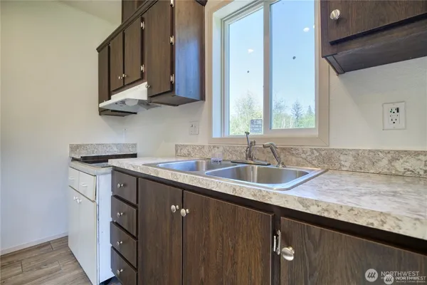a kitchen with stainless steel appliances granite countertop a sink stove and cabinets