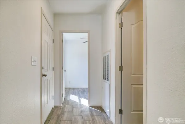 a view of a hallway with wooden floor