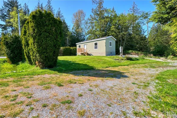 a house with a yard and large trees