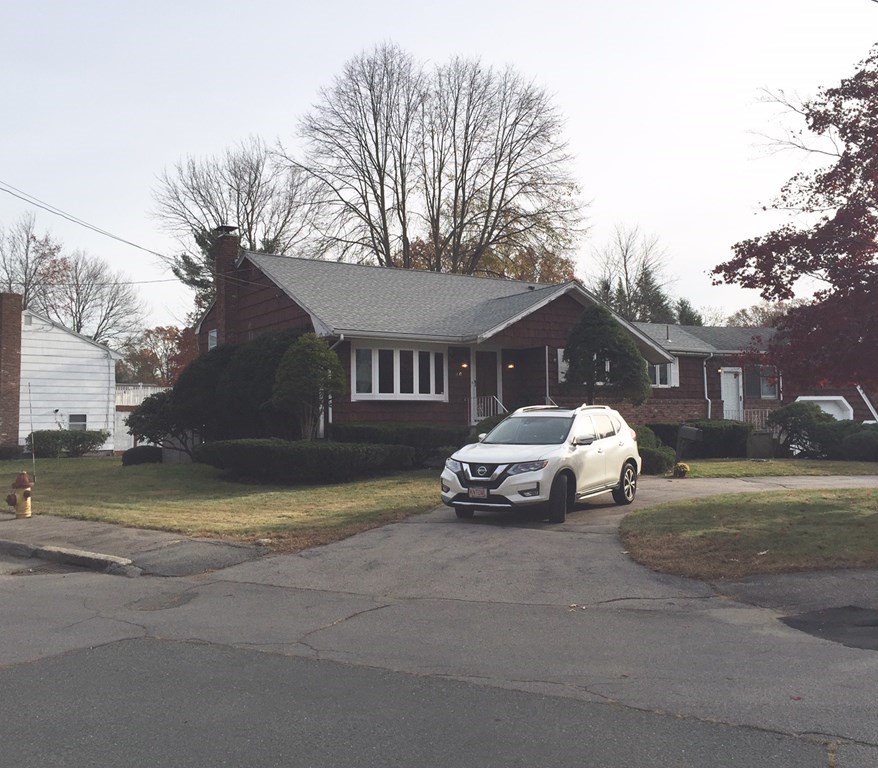 a view of a house with a yard and pathway