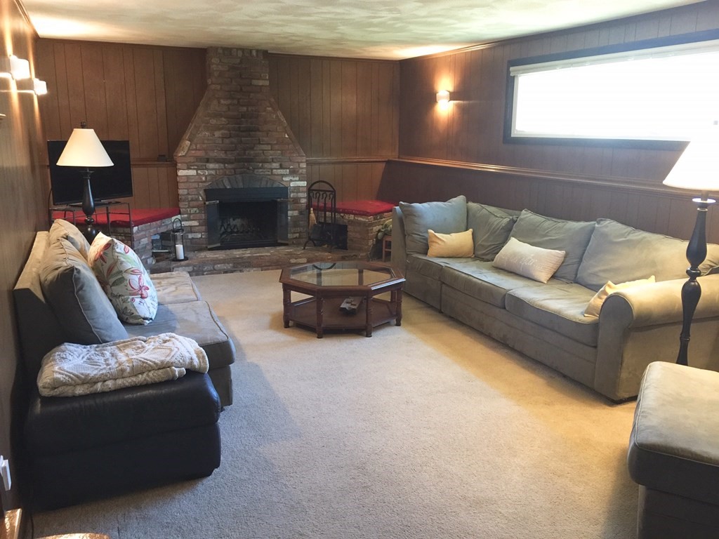 40 Niles Road Randolph, MA 02368 - Photo 11 of 29 a living room with furniture and a fireplace