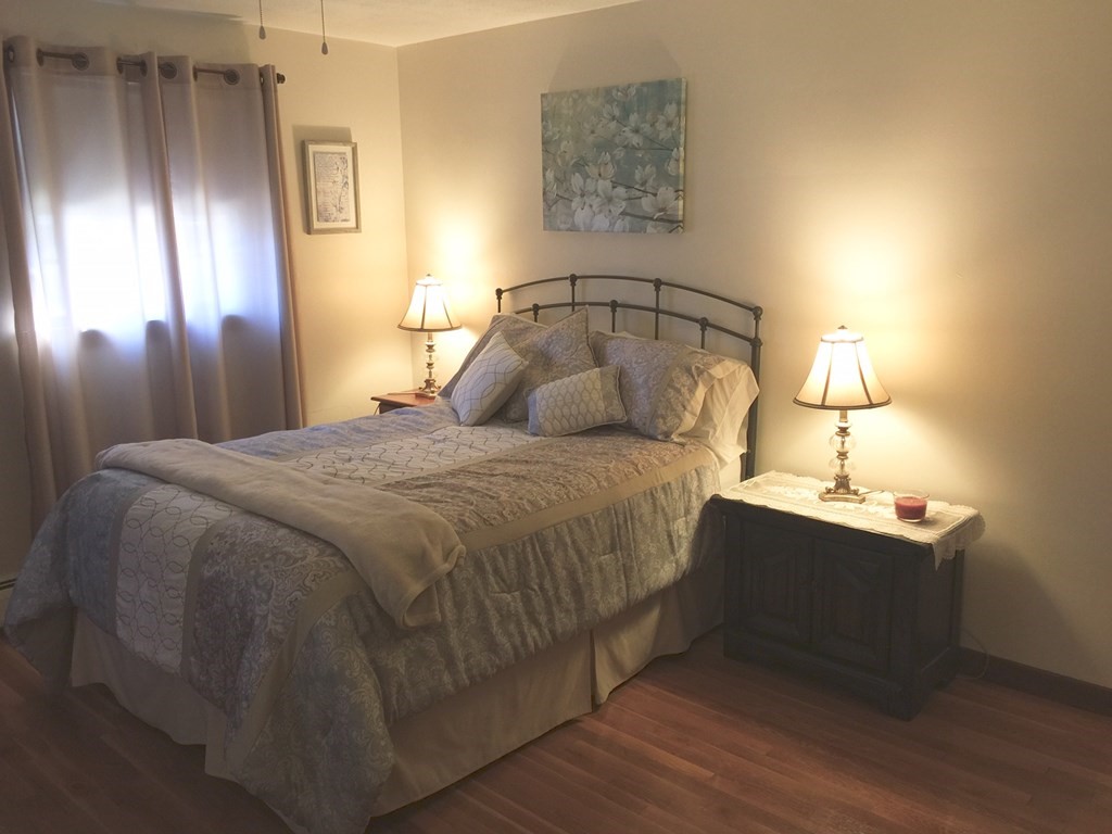 40 Niles Road Randolph, MA 02368 - Photo 16 of 29 a bedroom with a bed and a lamp