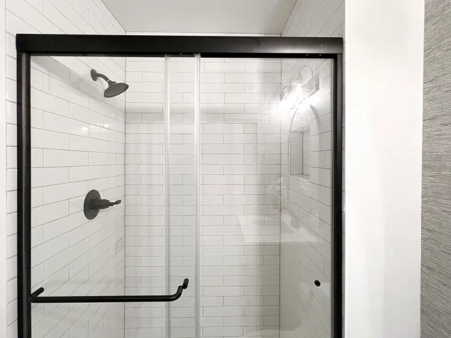 a bathroom with a glass shower door