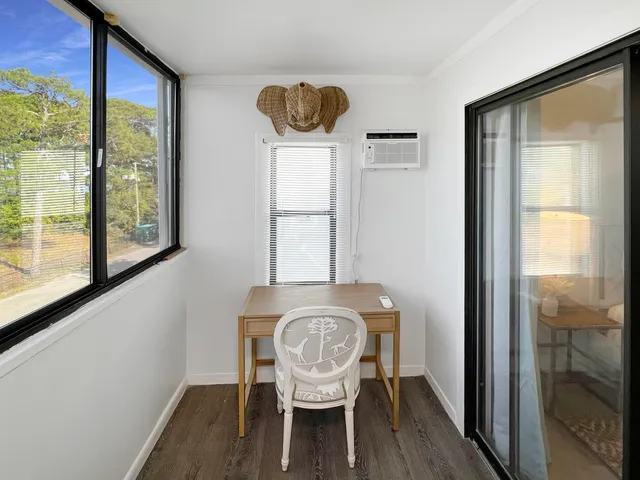 a dining room with furniture and a window