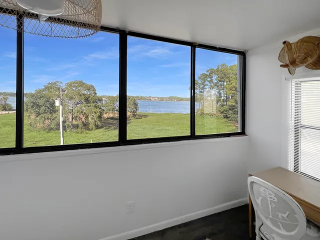 a view of a room that has a bed and a window