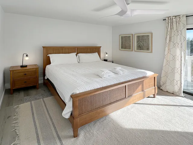 a bedroom with a bed and a night stand