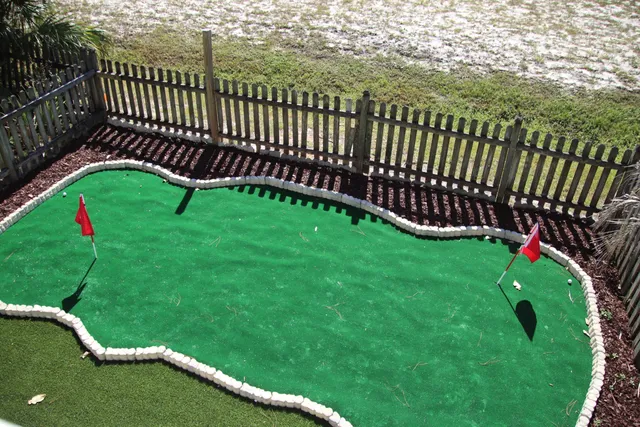 a view of a park with iron fence