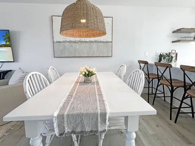 a view of a dining room with furniture and wooden floor