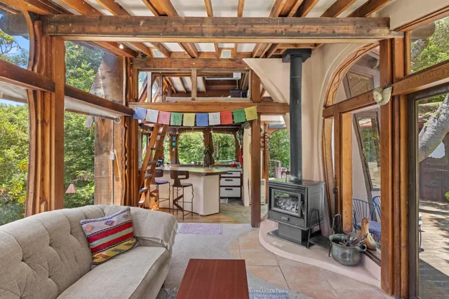 a living room with furniture and a floor to ceiling window