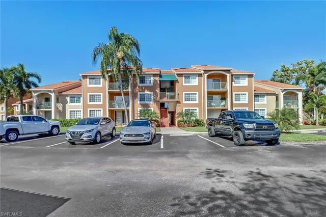 a car parked in front of a white house
