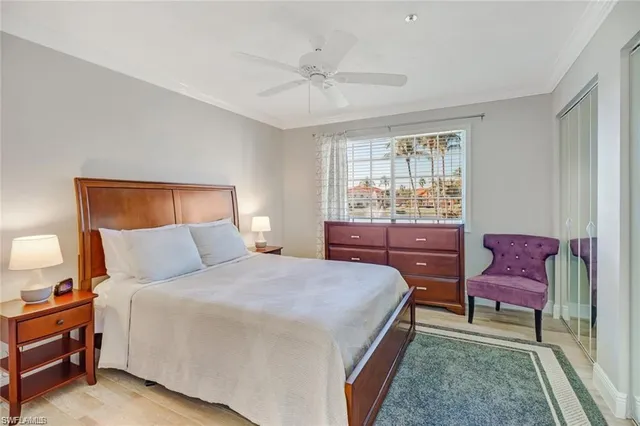 a bedroom with a bed window and a chair