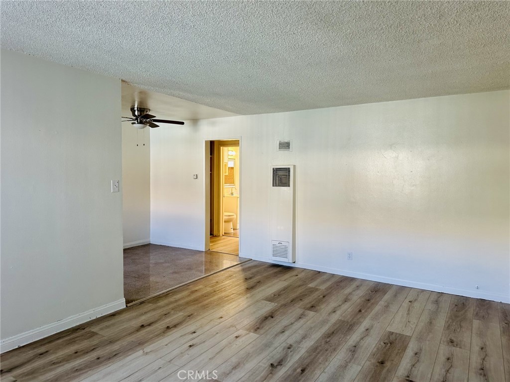 4830 Canoga Street, Unit E Montclair, CA 91763 - Photo 2 of 8 an empty room with wooden floor and closet