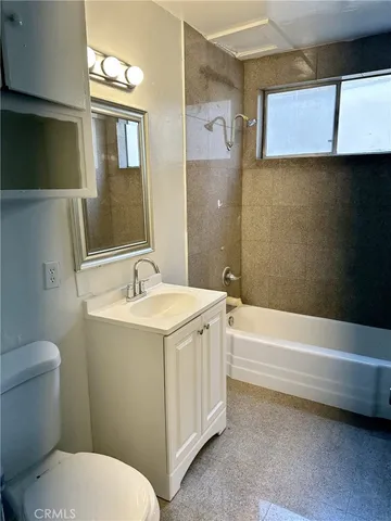a bathroom with a sink a toilet and bathtub