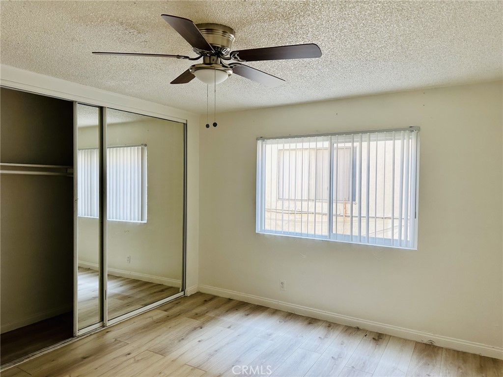 4830 Canoga Street, Unit E Montclair, CA 91763 - Photo 8 of 8 a view of an empty room with wooden floor and a window