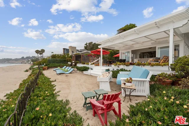 a group of people sitting on a pier next to a lake