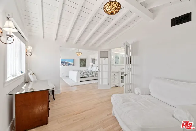 a spacious bedroom with a bed and a view of bathroom